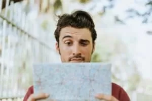 man reading a map and curious about levity